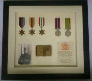 War service medals and memorabilia in a box frame