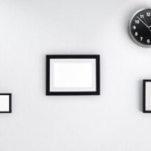 Picture frames and a clock on a wall